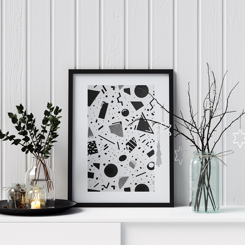 Modern black and white geometric artwork in a sleek black frame,