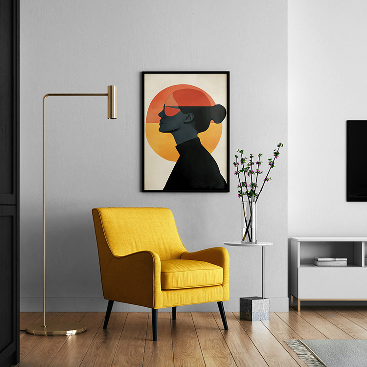 Framed minimalist poster of a woman's silhouette in profile against a large circular sunset with warm orange and yellow hues, displayed on a modern shelf with a green hanging lamp and a brass vase with greenery.